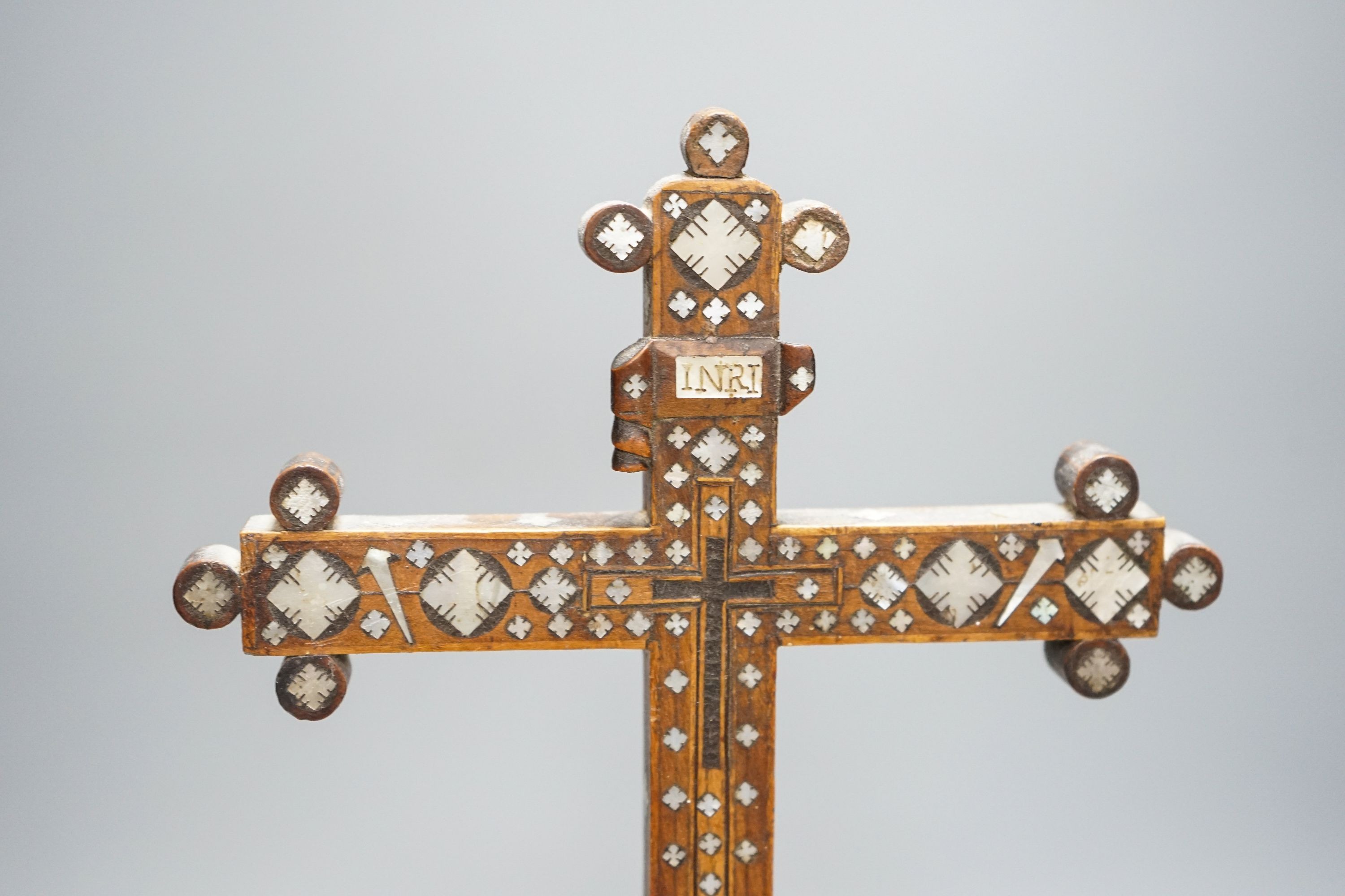 A 19th century Continental fruitwood crucifix with mother of pearl inlay, H 36cm